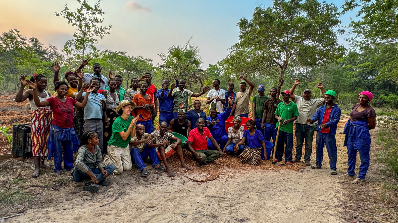 FLF team and community members celebrating at a reforestation site in the Miombo woodlands